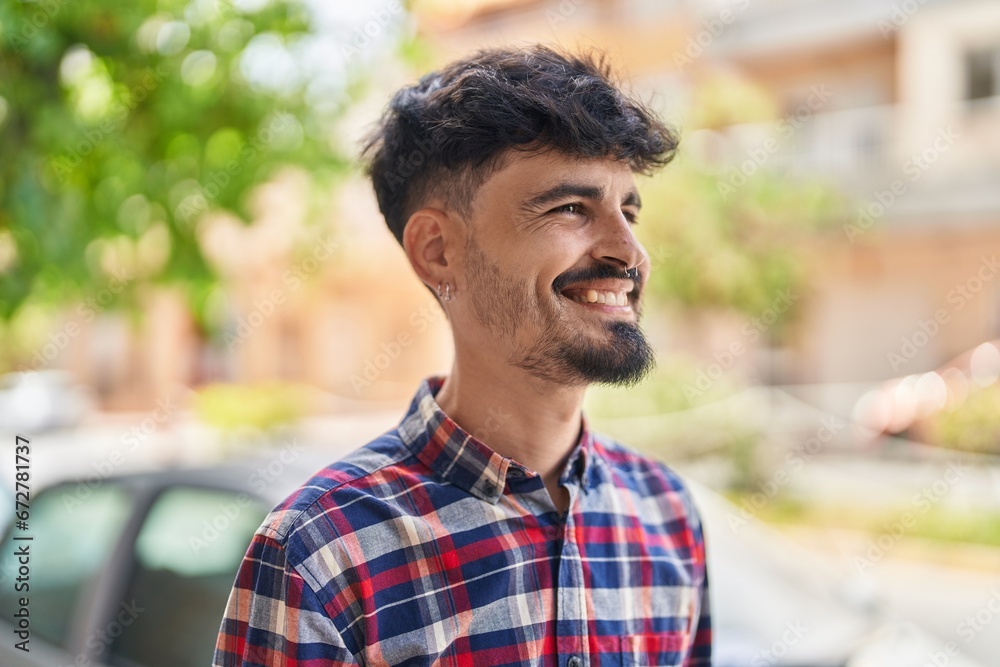 Young hispanic man smiling confident looking to the side at street Young hispanic man smiling confident looking to the side at street