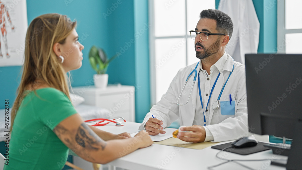 Man and woman doctor having medical consultation prescribing pills treatment at the clinic
