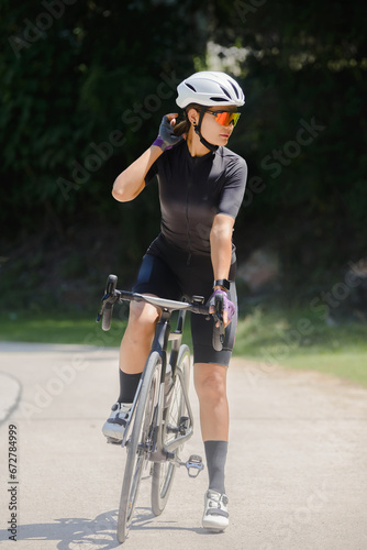 Concept woman riding bike.Cyclist Woman riding bike in helmets go in sport outdoor .Health care.