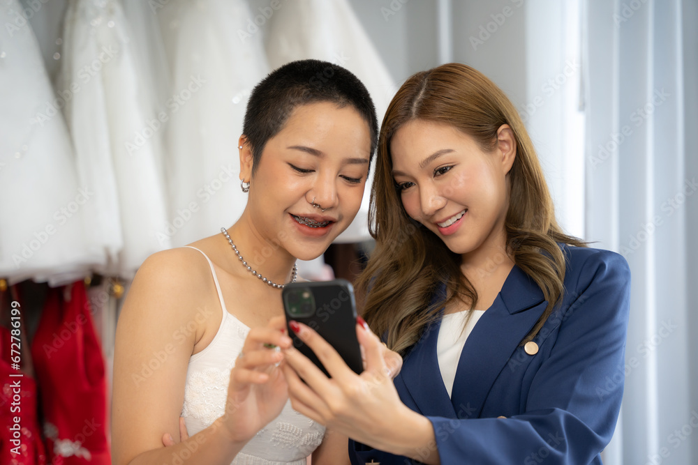 Beautiful female designer presenting wedding dress at shop. woman shop owner for pre wedding at wedding interior fashion studio. Beautiful female designer presenting wedding dress at shop. woman shop owner for pre wedding at wedding interior fashion studio.