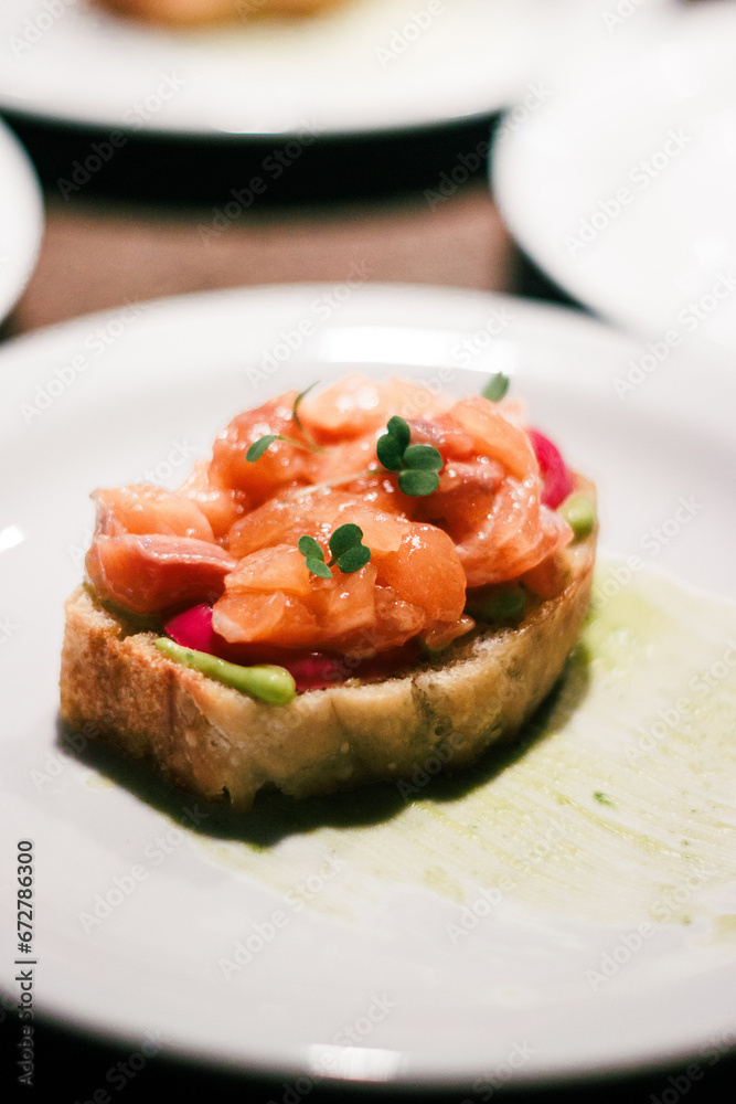 Salmon tartare on toast with green sauce, great for culinary arts and food blogs