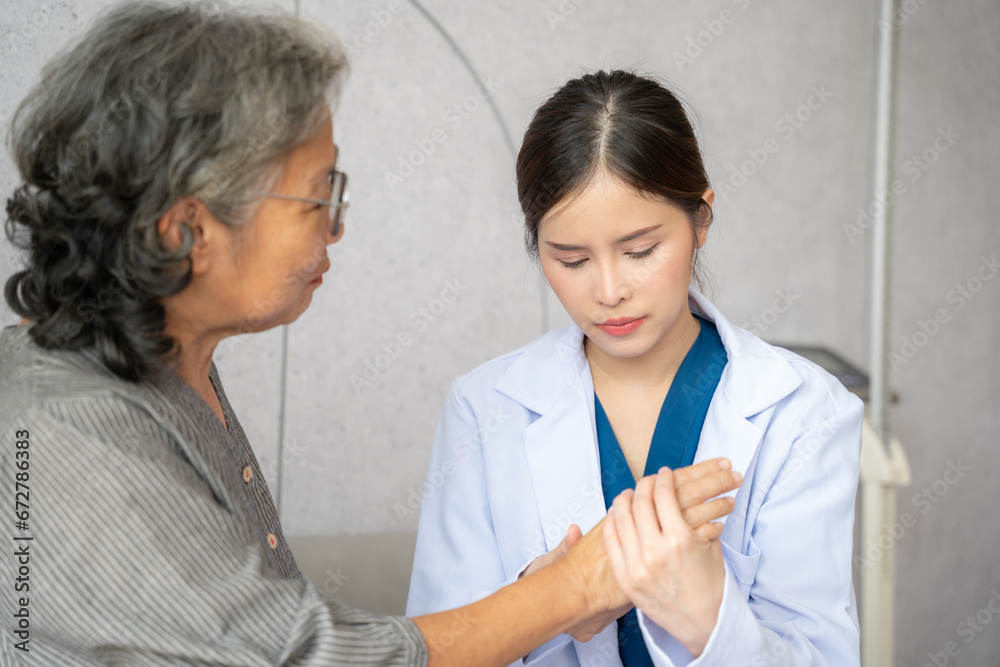 Beautiful nurse checks patient's hand in hospital room. She touching patient's hand in hospital room. Beautiful nurse checks patient's hand in hospital room. She touching patient's hand in hospital room.