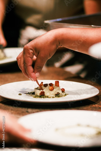 Final touch to risotto with bacon garnish, perfect for culinary sites