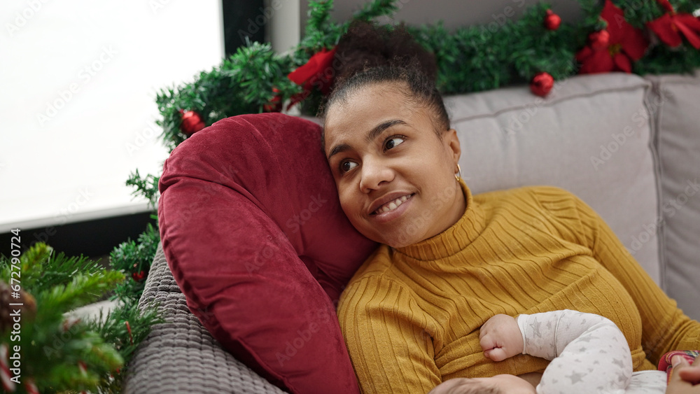 Mother and son celebrating christmas breastfeeding baby at home Mother and son celebrating christmas breastfeeding baby at home