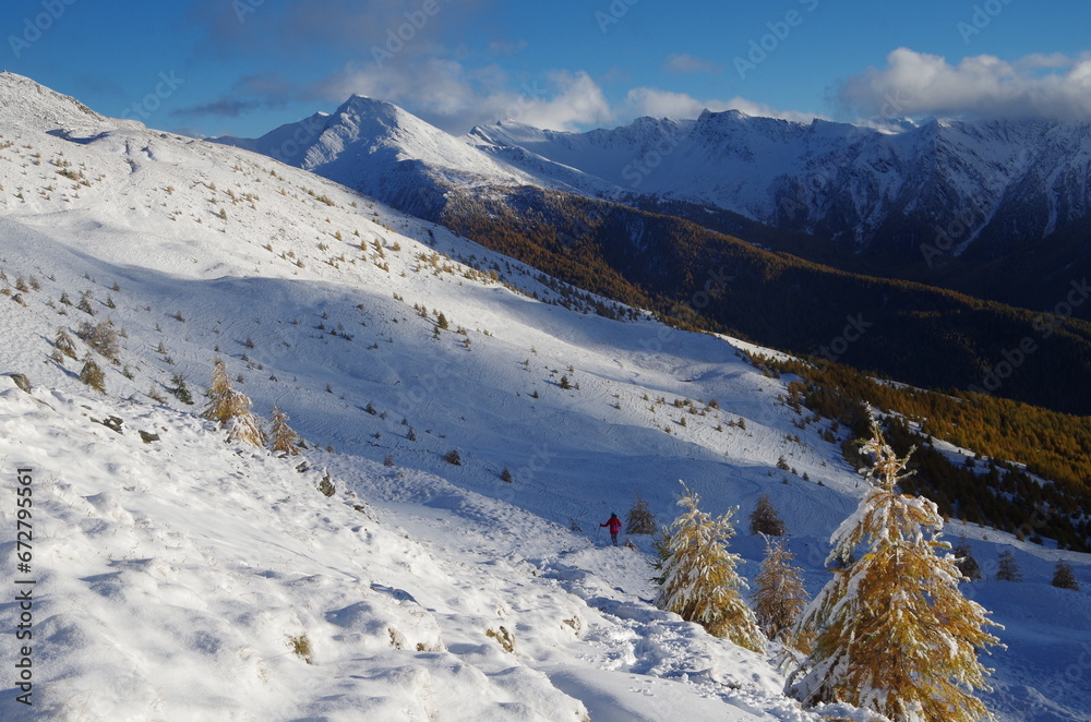 Girl hiking in french alps, beautiful snowy scenery, mountains peak, snow, sport extreem