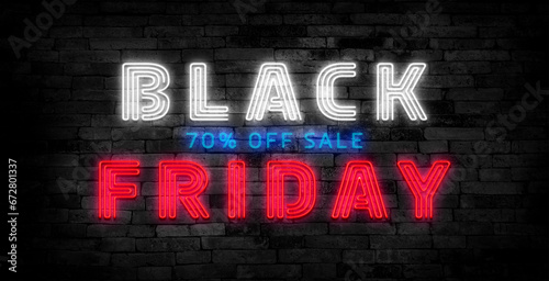 Black Friday text - blue neon letters light a dark brick wall.