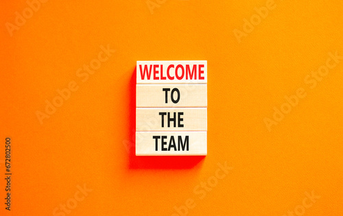 Welcome to the team symbol. Concept words Welcome to the team on beautiful wooden block. Beautiful orange table orange background. Business, motivational and welcome to the team concept.