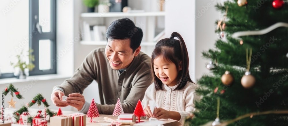 Happy father with daughter celebrating christmas and new year. Home holiday and Christmas tree Happy father with daughter celebrating christmas and new year. Home holiday and Christmas tree