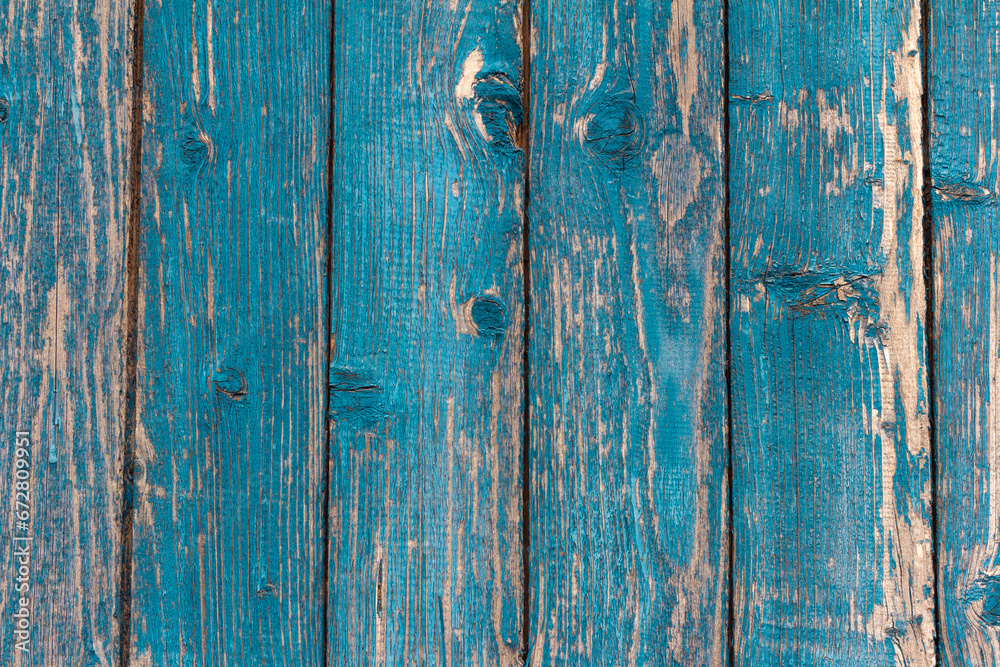 old wooden wall painted blue, weathered wooden background with nails and slits. old wooden wall painted blue, weathered wooden background with nails and slits.