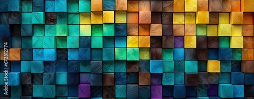 Wooden blocks, squares, cubes in green, turquoise and yellow colors for a wall texture. Grain and structure of wood. Wide format. Colorful cubes covering backdrop.