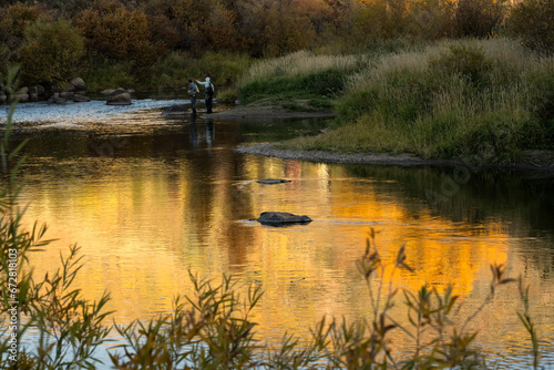 Fishing along the Yampa River at sunset; Steamboat Springs, Colorado photo