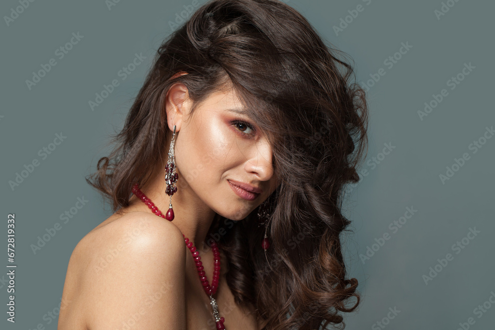 Perfect young sensual brunette woman in red garnet earring and necklace, closeup fashion beauty portrait