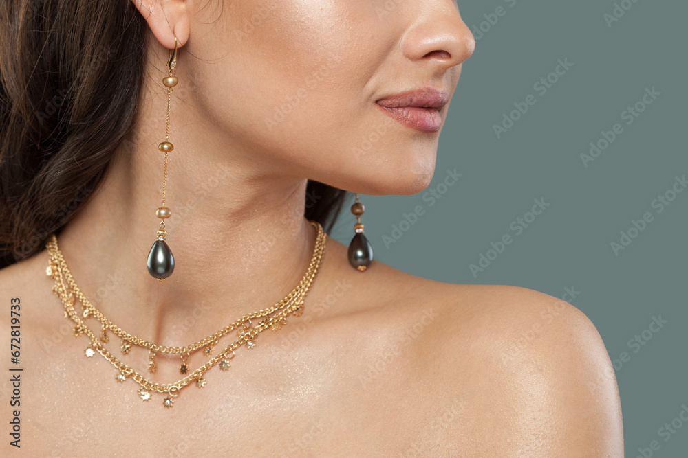 Gold jewelry necklace and long earring with black pearls, fashion studio portrait closeup