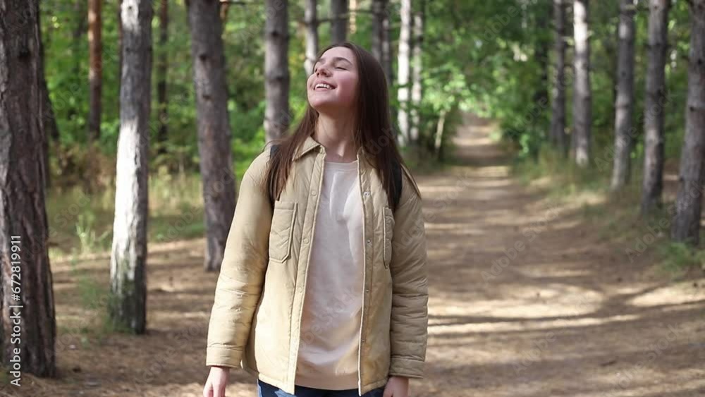 Teenage American girl young woman hiking with backpack in forest woodland. Video portrait of hiking teenager girl. Sport healthy concept. Teenage American girl young woman hiking with backpack in forest woodland. Video portrait of hiking teenager girl. Sport healthy concept.