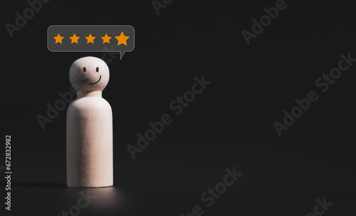 Concept of satisfaction in business services A wooden puppet block shows a satisfied face and a five-star message.