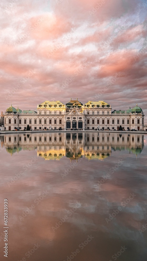 A vertical shot of the Austrian Gallery Belvedere reflected on the water
