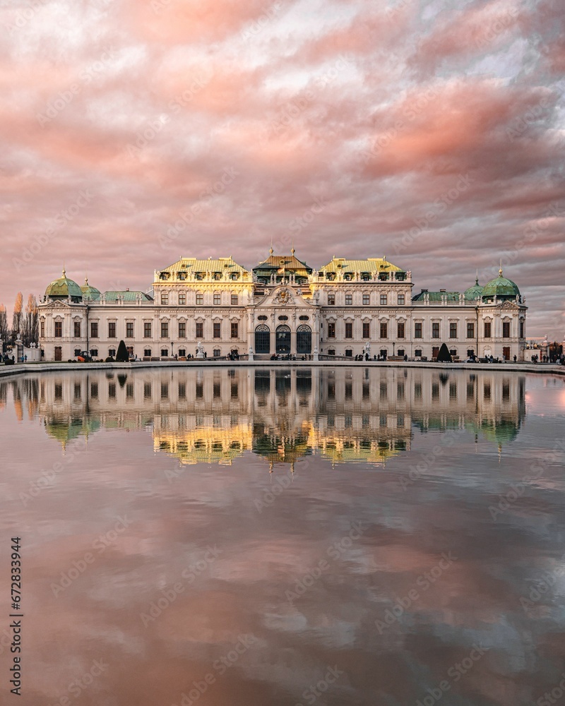 A vertical shot of the Austrian Gallery Belvedere reflected on the water