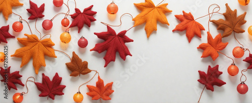 Maple leaf with felted lanterns on a white background.