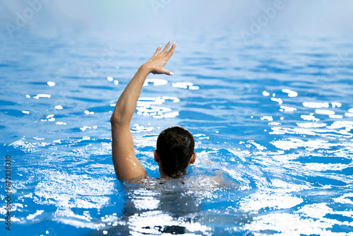 Obraz na plátně a synchronized swimming sportswoman practice new moves in the water of swimming