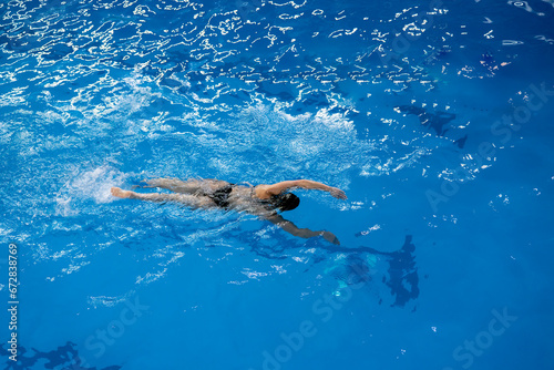 a female sport swimming athlete swimming underwater in the pool