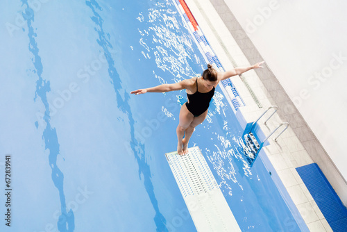 Wallpaper Mural female athlete stands on a springboard, diving competition Torontodigital.ca