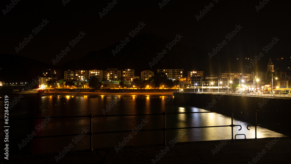 Lekeitio town night view from pier, Spain