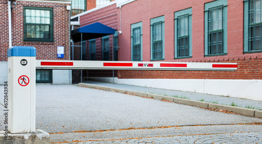 parking lot gate framed by soft sunlight, symbolizing access, security