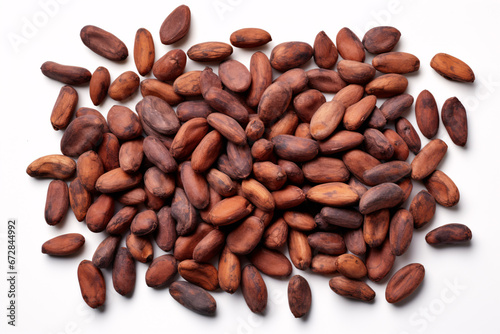 A top view of recently harvested cocoa fruit and undried/dried beans, displayed on a white surface. photo