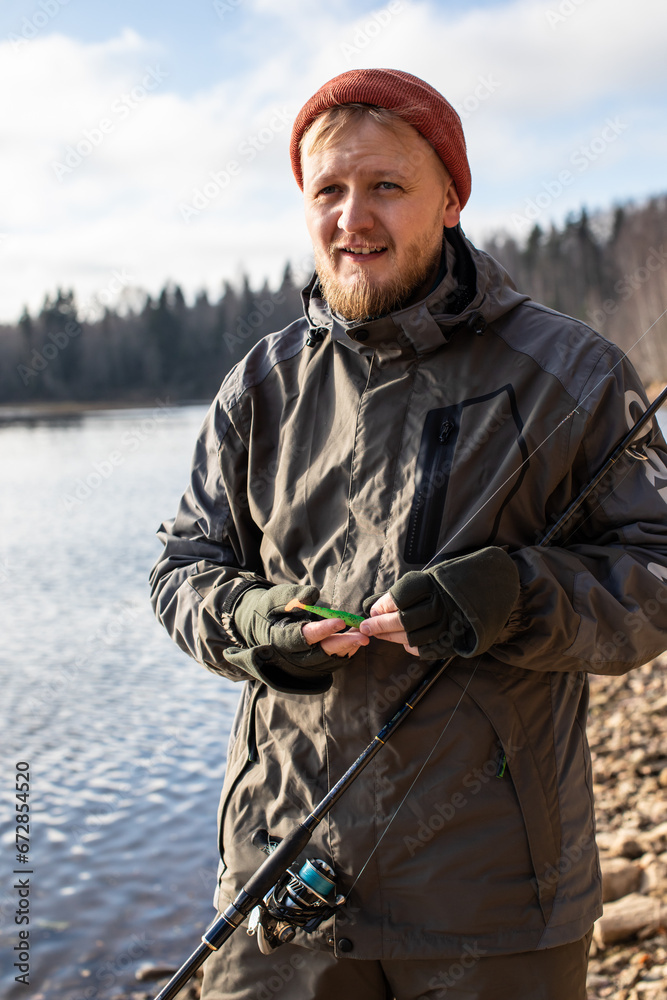Fototapeta premium fisherman fishing on the river bank, Fishing rod, spinning