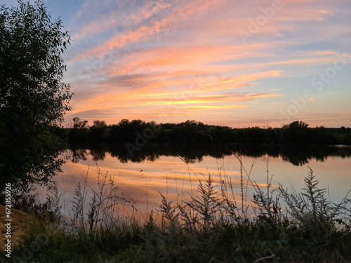 sunset over lake © Evgeniia