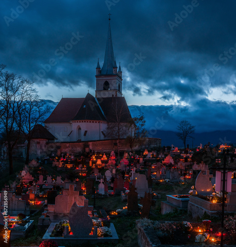 Night cemetery on All Saints' Day in Romani, Transylvania. Grave lights on All Saints' Day.

