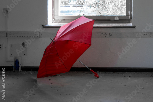 Fototapeta Naklejka Na Ścianę i Meble -  broken red umbrella in an abandoned factory