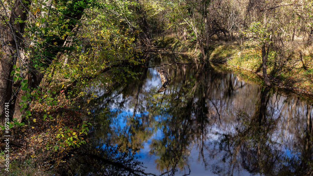 Scenic view of Calumet Creek near Clarksville, Missouri with surrounding landscape reflected in its waters Scenic view of Calumet Creek near Clarksville, Missouri with surrounding landscape reflected in its waters