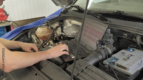 Wallpaper Mural Professional Car Mechanic Working on Laptop in Auto Repair Service Torontodigital.ca