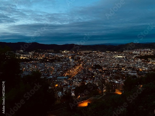 an evening shot looking over a city from the top of a hill