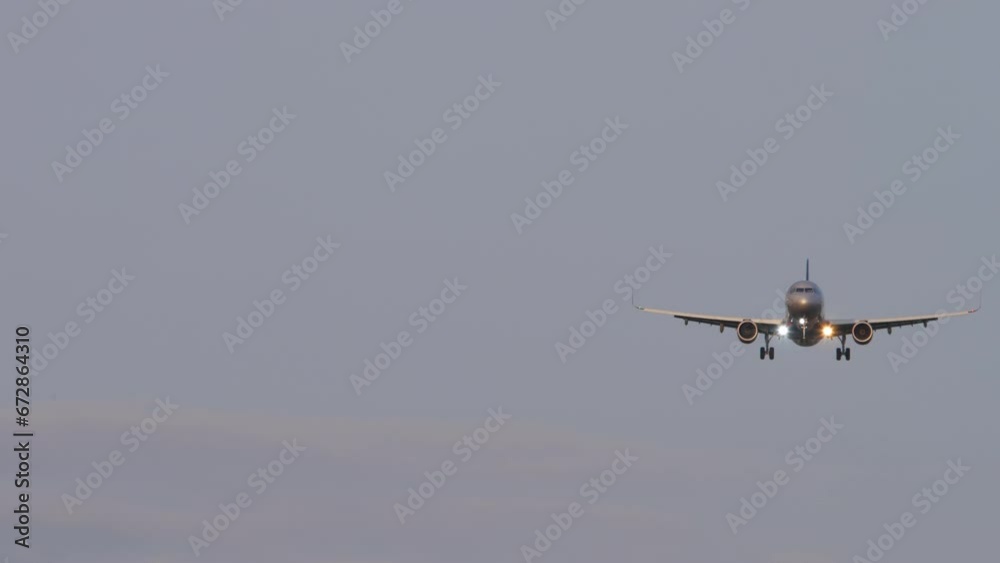 Jet plane approaching landing, front view. Airliner descent, arrival. Airplane in the sky. Travel concept Jet plane approaching landing, front view. Airliner descent, arrival. Airplane in the sky. Travel concept