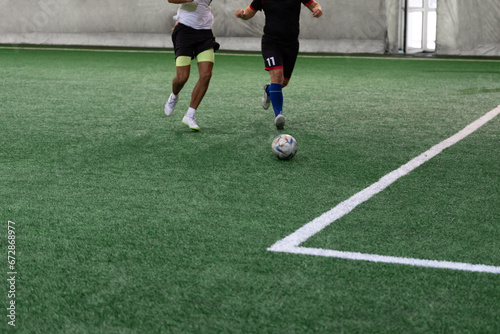 Fototapeta Naklejka Na Ścianę i Meble -  Futsal players rivals in action. Sport mini soccer futbol sala concept.