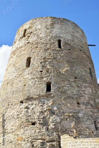 Stone tower of an ancient fortress against a blue sky