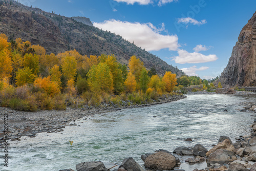 Autum Landscape of the North Fork of the Shoshone River in the Absaroka Mountains with Fall Color near Cody, Wyoming, USA photo