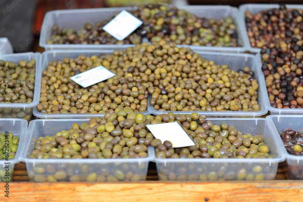 Plastic boxes containing table olives -mostly green- at a market stall, Pazari i Ri-New Bazaar. Tirana-Albania-001