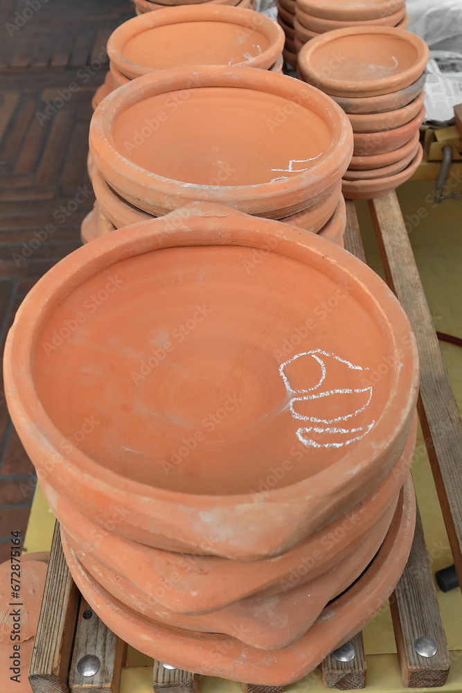 Traditional unglazed pottery for baking flat bread, market stall in the Pazari i Ri-New Bazaar, Old Town. Tirana-Albania-004 Traditional unglazed pottery for baking flat bread, market stall in the Pazari i Ri-New Bazaar, Old Town. Tirana-Albania-004