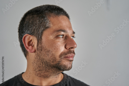 portrait of man looking to the right on neutral background