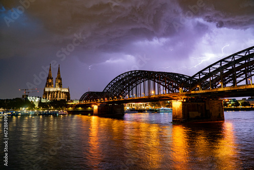 Lightning and dramatic storm clouds over Cologne Cathedral and Hohenzollern Bridge