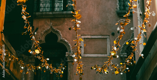 Wallpaper Mural Creative background. Venice Carnival. Glimpse of colorful houses with decorations. Hanging golden bulbs and discs. Torontodigital.ca