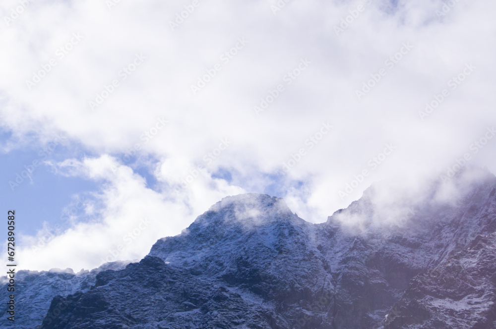 Tranquil Tatra mountain summit embraced by clouds, perfect for calm backgrounds and editorial use in travel and nature themes.