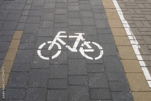 Bicycle path with bicycle signs painted and paved with road tiles.