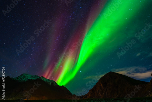 Fototapeta Naklejka Na Ścianę i Meble -  Awesome Northern lights over the snowy mountains. Lofoten islands, Norway.