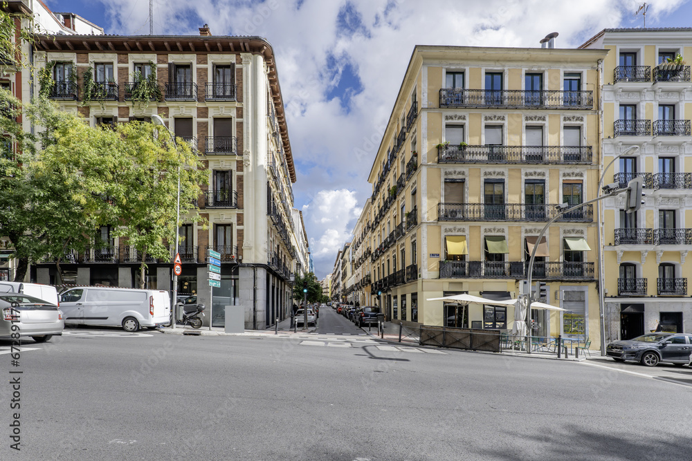 Facades of old urban residential housing on a ramp street in the city center of Madrid, Spain