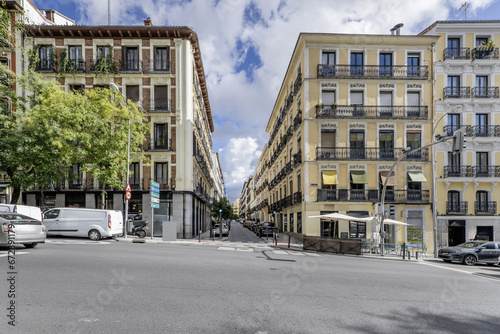 Facades of old urban residential housing on a ramp street in the city center of Madrid, Spain
