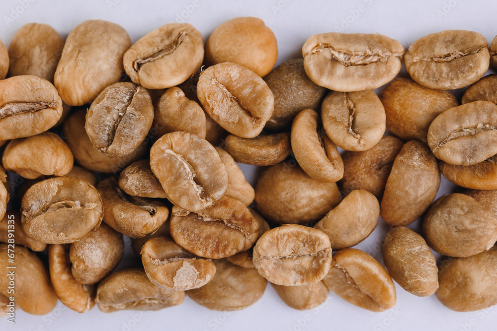 Macro fresh green raw roasting coffee beans, white isolated background Macro fresh green raw roasting coffee beans, white isolated background